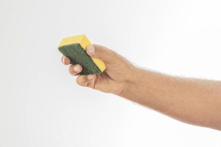 A dishwasher sponge held by a hand on a white background. Space to write. Close-upの写真素材