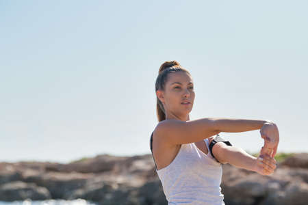 Pretty girl's face looking distractedly towards the front with her hair tied and wearing a sports shirt. Close-up.の写真素材