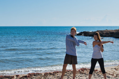 Beautiful beach with blue water and beautiful sand in which two young people are jercitando on a...