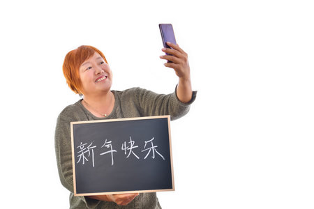 An Asian woman with a dark blackboard with Chinese symbol