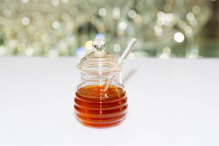 A jar of crystal honey and dipperの写真素材