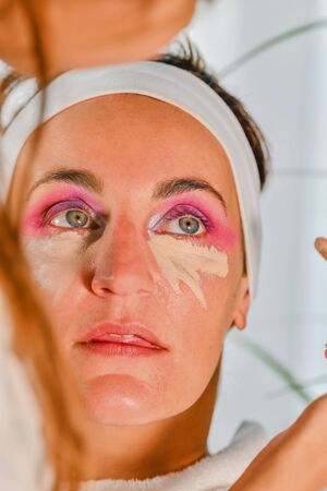 Close-up of a woman in the middle of a make-up sessionの写真素材