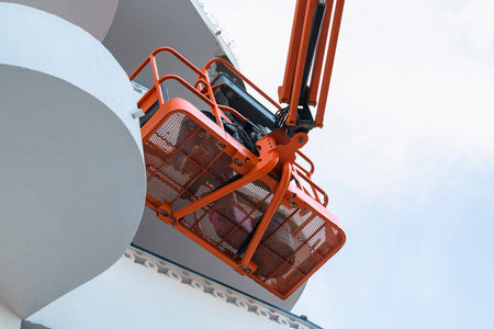 Man on a telescopic boom lift platform