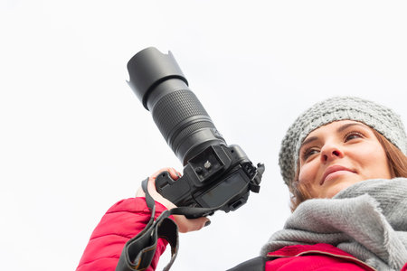 Happy looking teenager holding a dslr camera