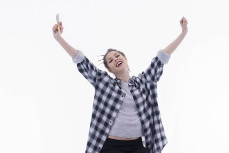 Young artist stretching her arms in a victory gestureの写真素材