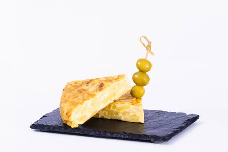Two delicious slices of spanish omelet with olivesの写真素材