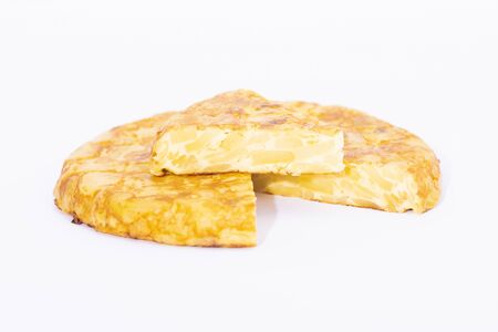 Traditional spanish omelet with a slice on topの写真素材