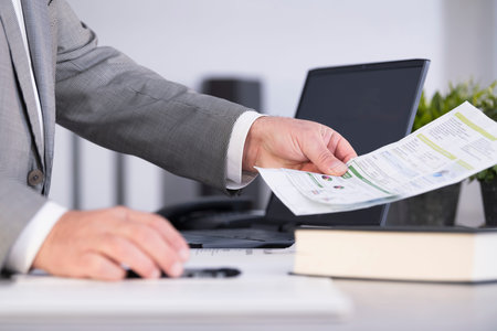 Male office worker hand holding a document