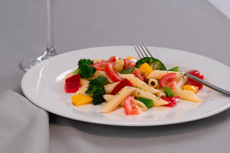 Selective focus and close up of delicious looking pasta and vegetables on a plate on a table. Healthy food and pasta concept.の写真素材