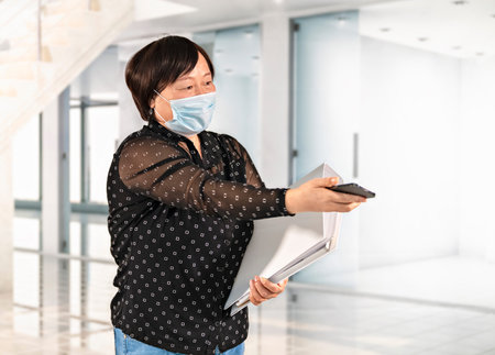 Woman offering her phone at an office