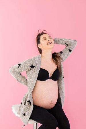 Happy looking pregnant woman posing and smiling