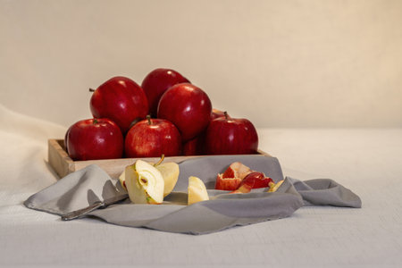 Sliced red apple and tray with more applesの写真素材