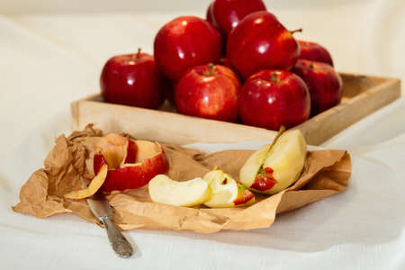 Sliced red apple with its skin on paperの写真素材