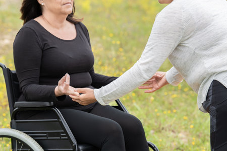 Woman in wheelchair being helped with meditation: selective focus. health and meditation concept.