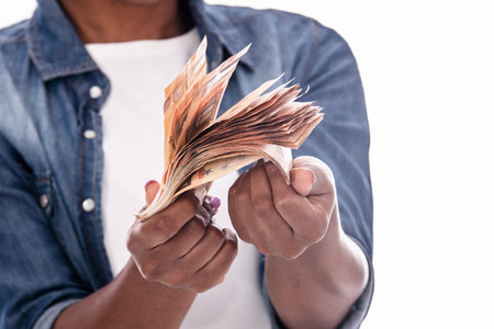 Close up of money bills held by african womans hands: Money concept