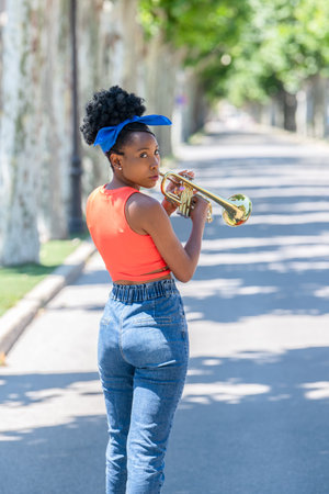 Back shot of latina woman ready to play a trumpet