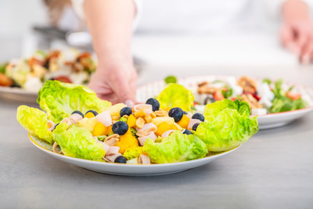 Mediterranean diet salad with peach, lettuce and turkey slices: selective focus