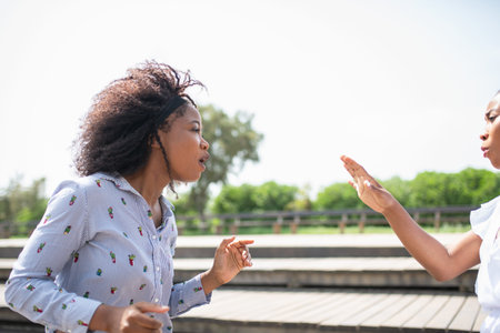 Two women confronting and arguing with each other.
