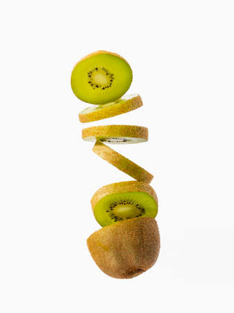 Close up of a sliced kiwi fallingの写真素材