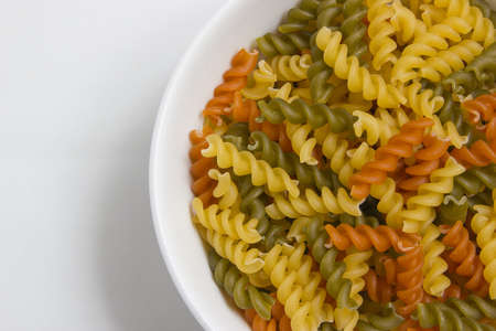 Fusilli pasta colored in a bowlの写真素材