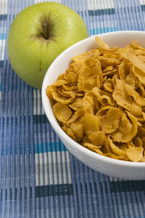 Healthy breakfast cereal and an appleの写真素材
