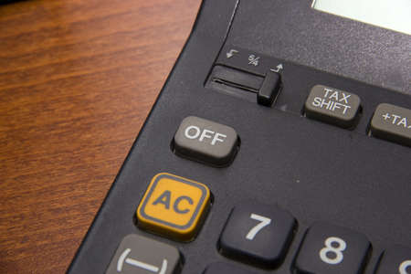 Off a calculator button on wooden backgroundの写真素材