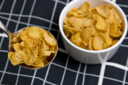 A spoonful of cereal with a bowl of background