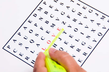 Wordsearch with the word love highlighted in yellow fluorescentの写真素材