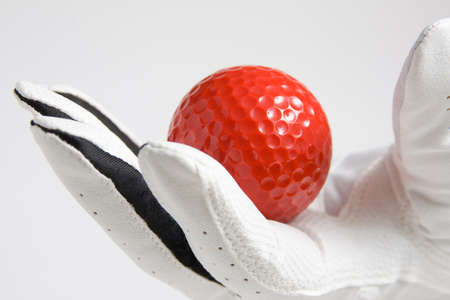golf ball endured by a gloveの写真素材