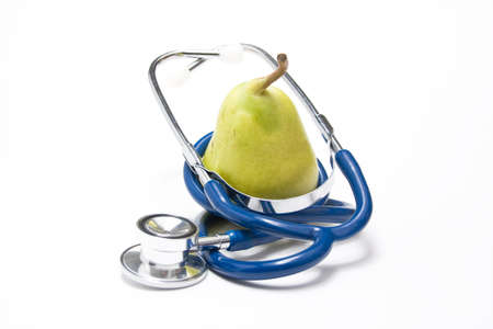 An pear surrounded by a stethoscopeの写真素材