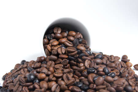 coffee beans out of a white cupの写真素材