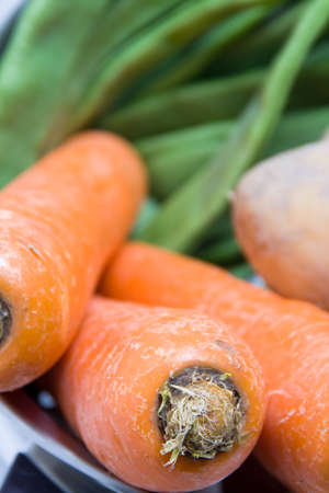 Forefront of a carrot background with green beansの写真素材