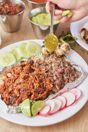 girl eating delicious typical mexican food, tacos, sopes, pastor, etc. variety of delicious typical mexican foodの写真素材