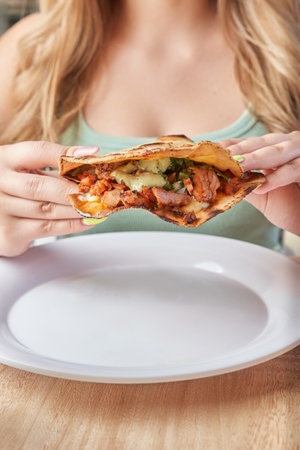 girl eating delicious typical mexican food, tacos, sopes, pastor, etc. variety of delicious typical mexican foodの写真素材
