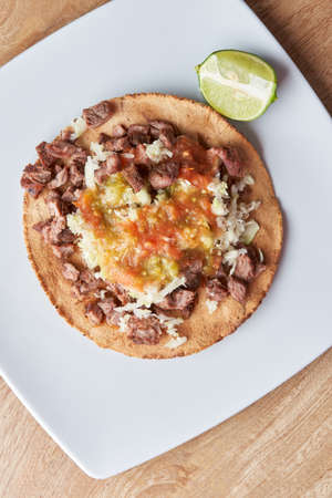 variety of delicious typical mexican food and ingredients such as salsas, red, green, guacamole, lemon, tomato and onion.の写真素材