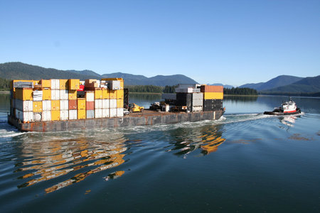 Tugboat with Barge in Calm Alaska Waterway