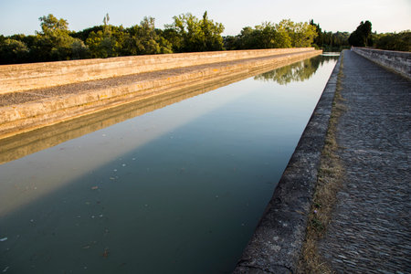 The Canal du Midi in Beziers at sunset, a long canal that connects the Atlantic Ocean with the Mediterranean Sea in Southern France. A world heritage site since 1996のeditorial素材