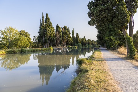 The Canal du Midi in Beziers at sunset, a long canal that connects the Atlantic Ocean with the Mediterranean Sea in Southern France. A world heritage site since 1996の写真素材