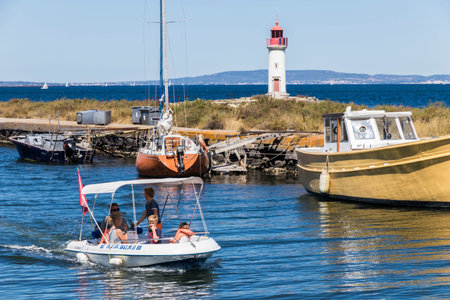 Boats in the Canal du Midi, with the Les Onglous lighthouse in the background.のeditorial素材