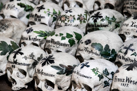 Skulls painted with names, colorful flowers and crosses in the Charnel House or Beinhaus, Hallstatt, Austriaの写真素材
