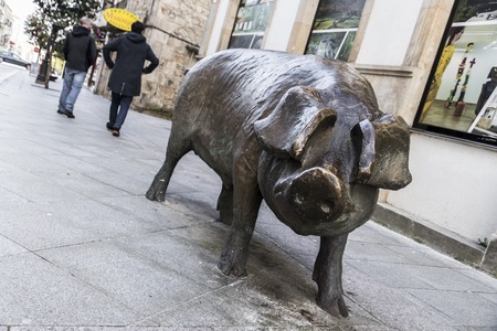 Bronze statue of a pig in the streets of Lalin, Galicia, Spain, as a commemorative monument to the traditional Galician Stew (Cocido Galego)のeditorial素材