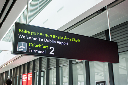 Bilingual signs in Irish and English at Dublin Airport (Aerfort Bhaile Atha Cliath), Republic of Irelandの写真素材