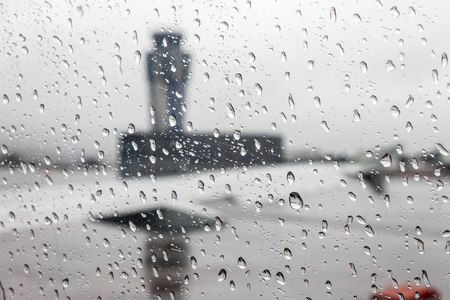 Views of the Santiago de Compostela - Lavacolla Airport air traffic control tower on a rainy day, through an aircraft window covered with raindrops, Spainの写真素材