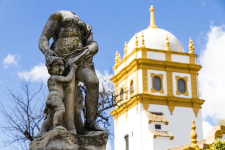 Seville, Spain. Views of a headless statue in the Jardines de las Delicias public gardens, with the tower of the Pabellon de Argentina (Argentine Pavilion) of the Ibero-American Exposition of 1929の写真素材