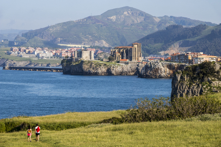 Castro Urdiales, Spain. Views of Santa Maria de la Asuncion Church and Castle of Santa Ana lighthouse from the Cementerio de Ballenaのeditorial素材