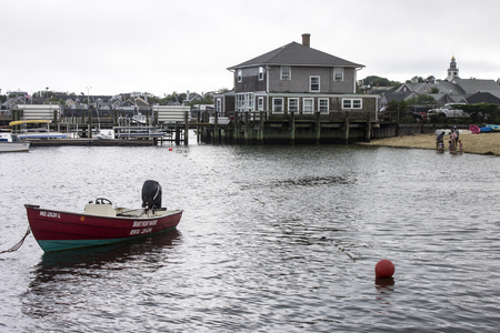 Nantucket island, Massachusetts. Views of the Nantucket harbor with boats and traditional wooden houses on a misty summer dayのeditorial素材