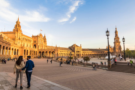 Seville, Spain. A couple walks at sunset in the Plaza de Espana (Spain Square), a major landmark in the city of Sevilla designed by Anibal Gonzalezのeditorial素材