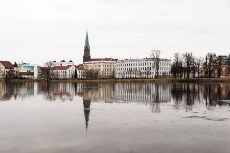 Schwerin, Germany. Views of the buildings of the Old Town reflected in the Schweriner See lake at duskのeditorial素材