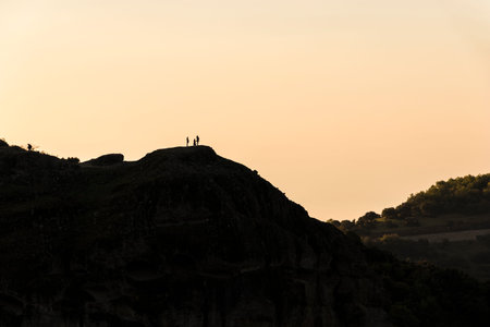 Kalabaka, Greece. Silhouetted photographers taking pictures of the monasteries of Meteora in the...