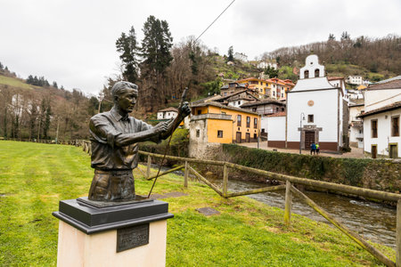 Cangas del Narcea, Spain. Statue of El Tirador (a fireworks operator), with views of the traditional...